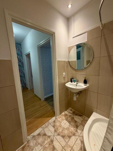 a bathroom with a sink and a mirror at Rynek Ratusz in Wrocław