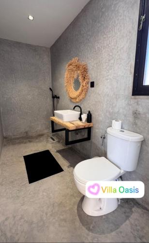 Villa Oasis Marrakech في مراكش: حمام مع مرحاض أبيض ومغسلة