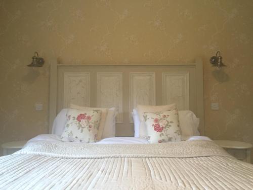 a bed with two pillows on top of it at Riverbank, Country Pub and Guesthouse in Carrickmacross