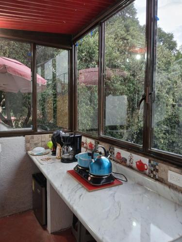 a kitchen counter with some pots and pans on it at Habitación en barrio de Jalatlaco in Oaxaca City