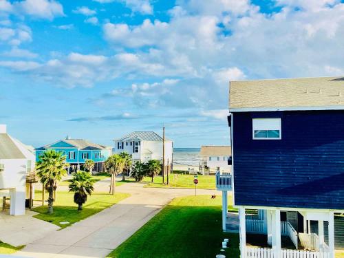 a blue house with a view of the ocean at Saltwater Solace For 8 in Galveston