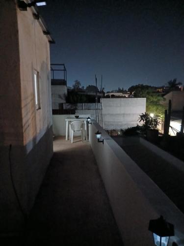 a night view of a balcony with a table on a building at Habitación en barrio de Jalatlaco in Oaxaca City