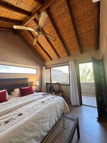 a bedroom with a bed and a ceiling fan at Vientonorte in Tilcara