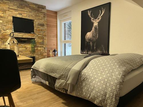 a bedroom with a picture of a deer on the wall at Studio Chalet Centre in Gérardmer