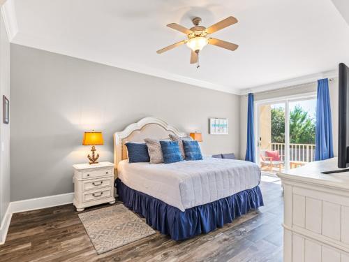 a bedroom with a bed and a ceiling fan at Sanctuary at Redfish 1106 by Newman-Dailey in Blue Mountain Beach