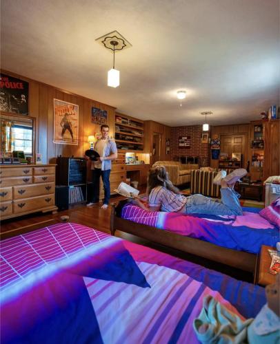 a group of people sitting on beds in a room at 1980's Themed Room with MASSIVE 80's Arcade in Winston-Salem
