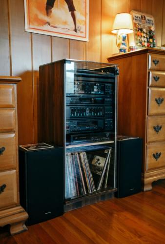 a cabinet filled with music and dvds at 1980's Themed Room with MASSIVE 80's Arcade in Winston-Salem