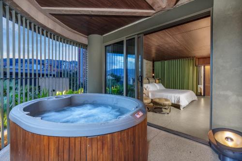 a jacuzzi tub in a room with a bedroom at 23 Living in Medellín