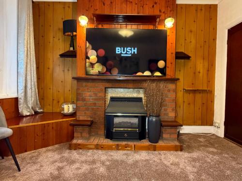 a brick fireplace with a stove in a living room at Spacious 3 Bedroom House in Doncaster with Vintage Charm in Doncaster