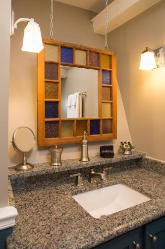 a bathroom with a sink and a mirror at Andon-Reid Inn Bed & Breakfast in Waynesville