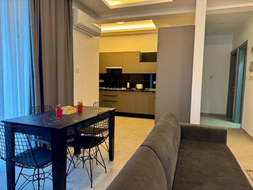 a living room with a couch and a table at Sogular Apartments 1 in Aglantzia