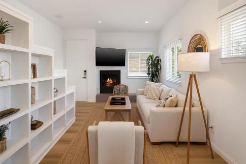 a living room with a white couch and a fireplace at Exclusive 2BD 3BA with Balcony in Los Angeles