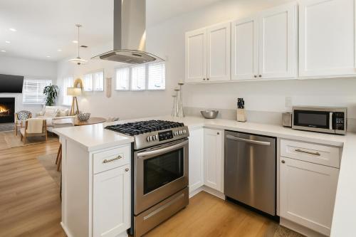 a kitchen with white cabinets and a stove top oven at Exclusive 2BD 3BA with Balcony in Los Angeles
