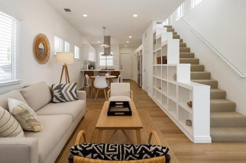 a living room with a couch and a staircase at Exclusive 2BD 3BA with Balcony in Los Angeles