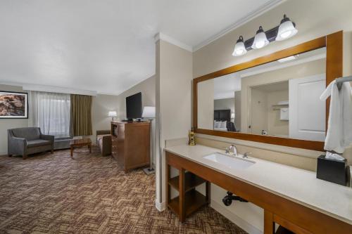 a hotel room with a sink and a mirror at Best Western Plus Northwoods Inn in Crescent City