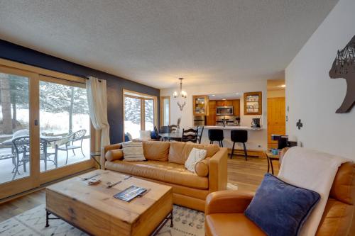 a living room with a couch and a table at Charming Vail Condo with Patio and Mountain Views in Vail