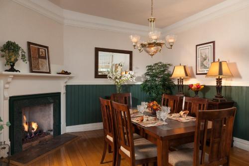 a dining room with a table and a fireplace at Andon-Reid Inn Bed & Breakfast in Waynesville