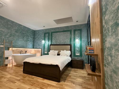 a bedroom with a bed and a tub and a television at Ursachi Apartaments & Rooms in Suceava