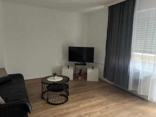 a living room with a couch and a television at Corner of Serenity in Saint-Louis