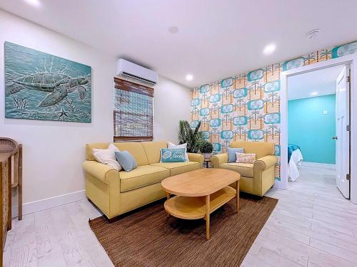 a living room with a couch and a table at Just Beachy! One bed one bath charmer steps to beach in Bradenton Beach