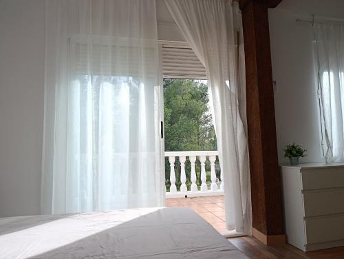 a bedroom with a bed and a large window at El otro cielo Playamonte in Navarrés