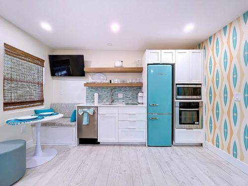 a kitchen with a blue refrigerator in a room at Reel Paradise steps to bay beach fishing dock in Bradenton Beach