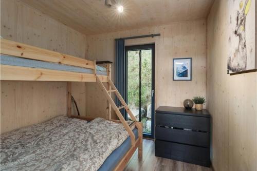 a bedroom with two bunk beds and a window at Unique Hideaway by Krøderen - Beach, Boat & Hiking in Ørgenvika