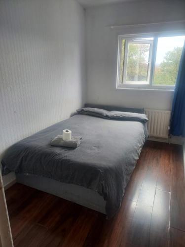a bed in a room with a window at Guest Stay in London