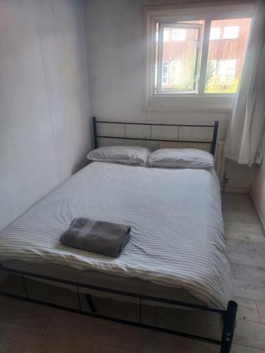 a bed in a bedroom with a pillow on it at Guest Stay in London