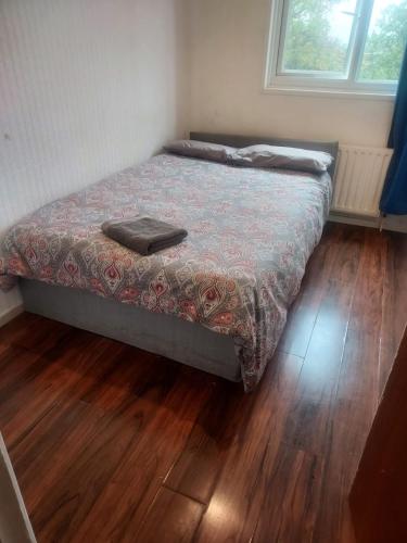 a bed in a room with a wooden floor at Guest Stay in London
