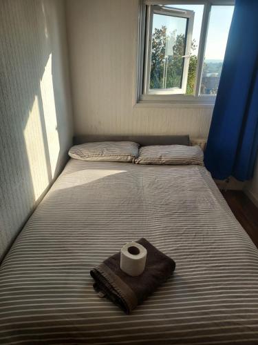 a bed with a roll of toilet paper on it at Guest Stay in London