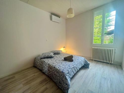 Llit o llits en una habitació de Maison proche TRAM D