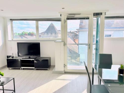 a living room with a tv and a large window at Modern 2 Bed Apartment in York City Centre - Best York Location - Steps from Top Attractions in York