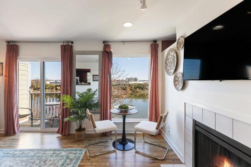 a living room with a fireplace and a tv at Downtown Riverfront Condo unit 780 in Nashville