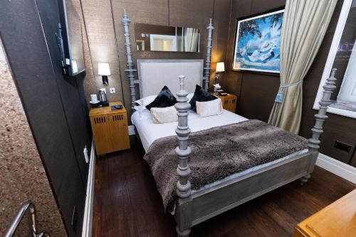a bedroom with a bed and a ladder at Karma Sanctum Soho Hotel in London