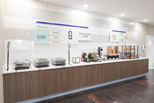 a kitchen with a counter with three pans on it at Garner Hotel Glen Burnie BWI Airport Area by IHG in Glen Burnie