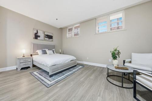 a white bedroom with a bed and a couch at Chic Studio Retreat in New Haven in New Haven