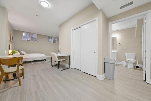 a living room with a bed and a table and a door at Chic Studio Retreat in New Haven in New Haven