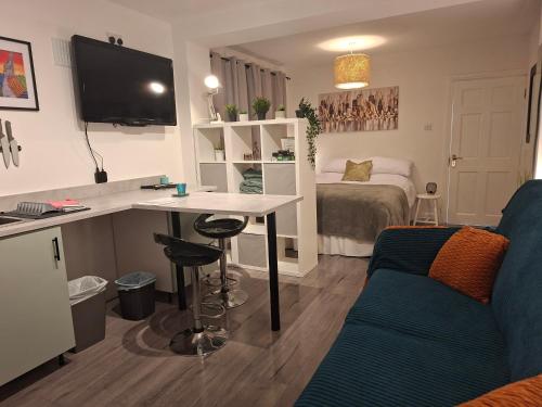 a room with a bed and a desk and a couch at The Éire Escape Studio in Slane