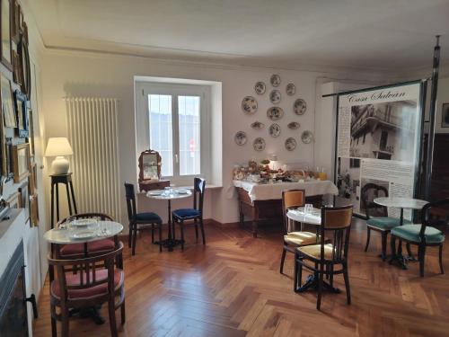 a room with tables and chairs and a dining room at Casa Salvàn in Rodello