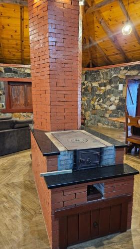 a kitchen with an island with a stove in a room at SIG - Rancho Desiam - Serra Gaúcha in Gramado