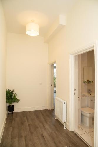 an empty living room with a toilet and a sink at Seaview Apartments - 28-29 Marine Parade, Harwich - Perfect for business & long term stays in Dovercourt