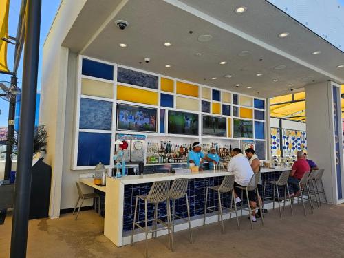 a restaurant with people sitting at a bar at Easy access unit at the main strip in Las Vegas