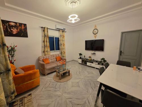 a living room filled with furniture and a flat screen tv at Résidence Éden San pedro in San-Pédro