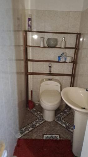 a bathroom with a toilet and a sink at samargo in Cali