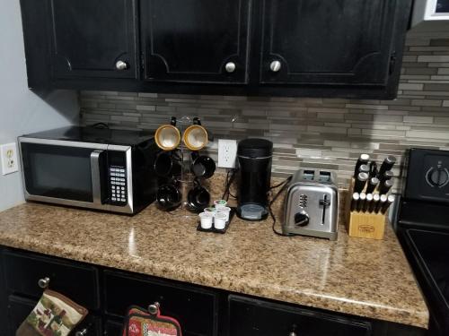 un comptoir de cuisine avec un micro-ondes et des appareils électroménagers dessus dans l'établissement Home away from Home Comfort, à Savannah