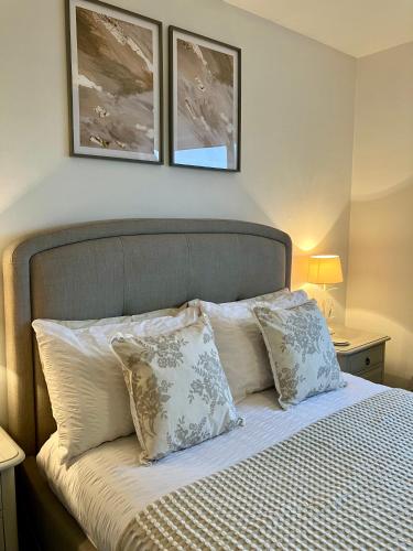a bedroom with a bed with two pictures on the wall at Central & Cosy, Home from Home with Large Garden & Free Parking, Bournemouth in Bournemouth