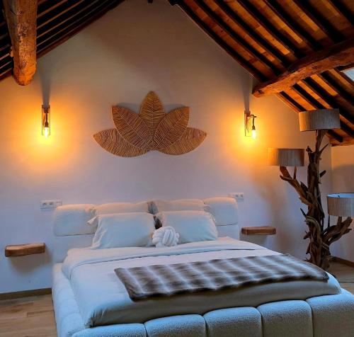 a bedroom with a large bed with a large flower on the wall at Domaine de Donstiennes in Thuin