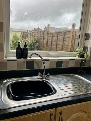a kitchen sink in front of a window with a view at Central & Cosy, Home from Home with Large Garden & Free Parking, Bournemouth in Bournemouth