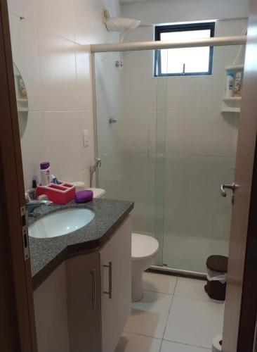 a bathroom with a sink and a toilet and a shower at Alugo Quarto somente uma pessoa in Maceió